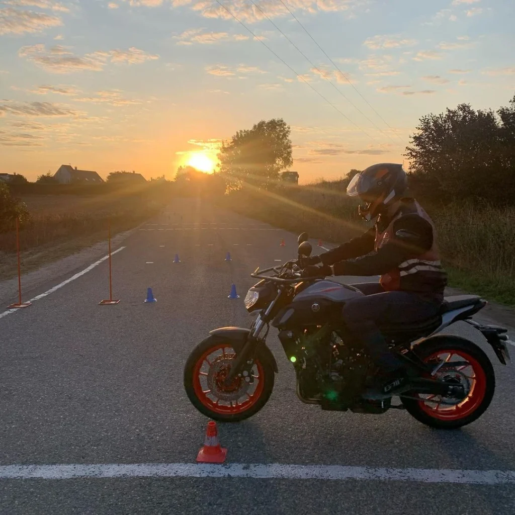 Motard de l’auto-école au coucher du soleil sur la piste